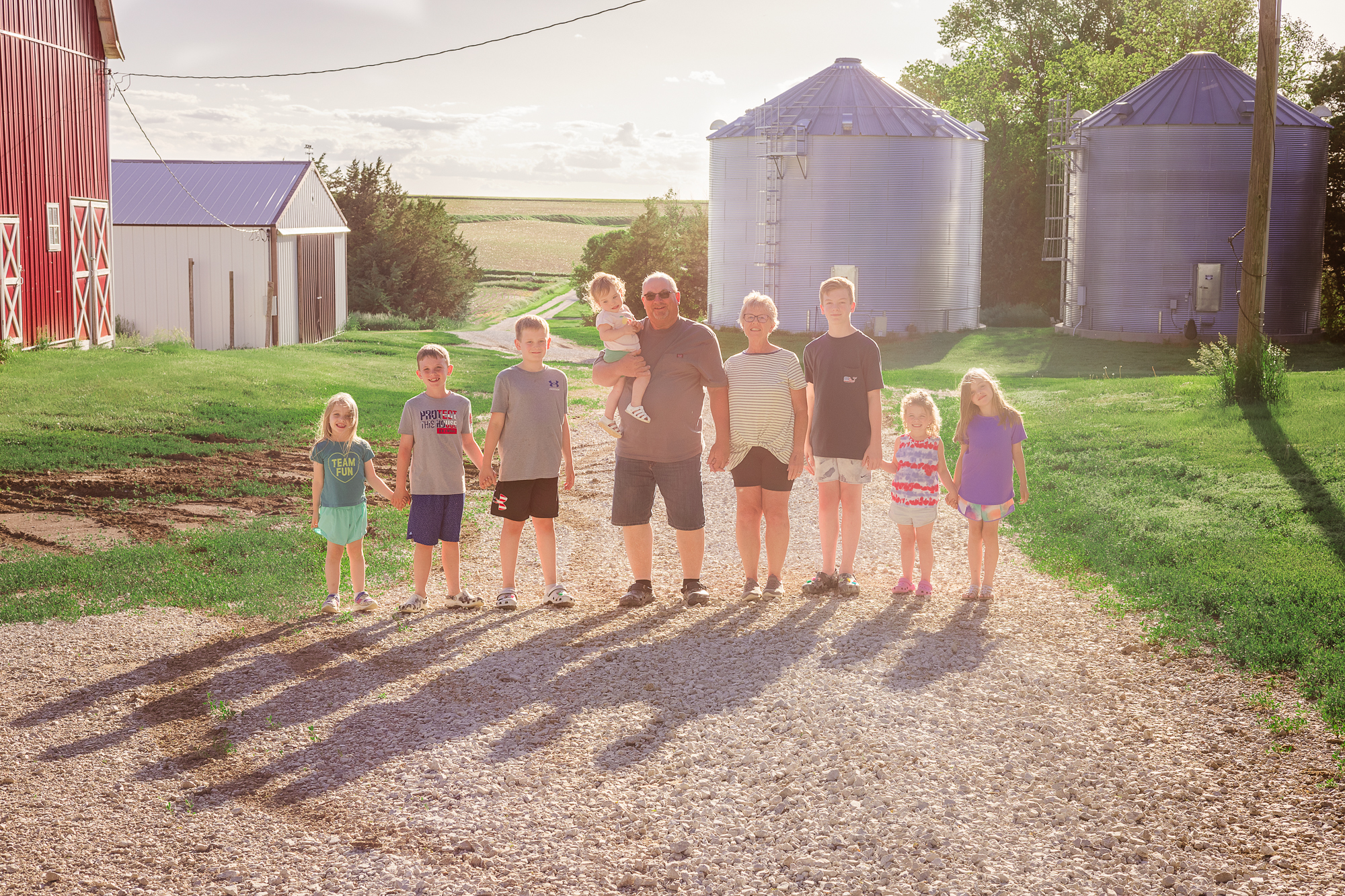 Grandparents with grandchildren on the family farm