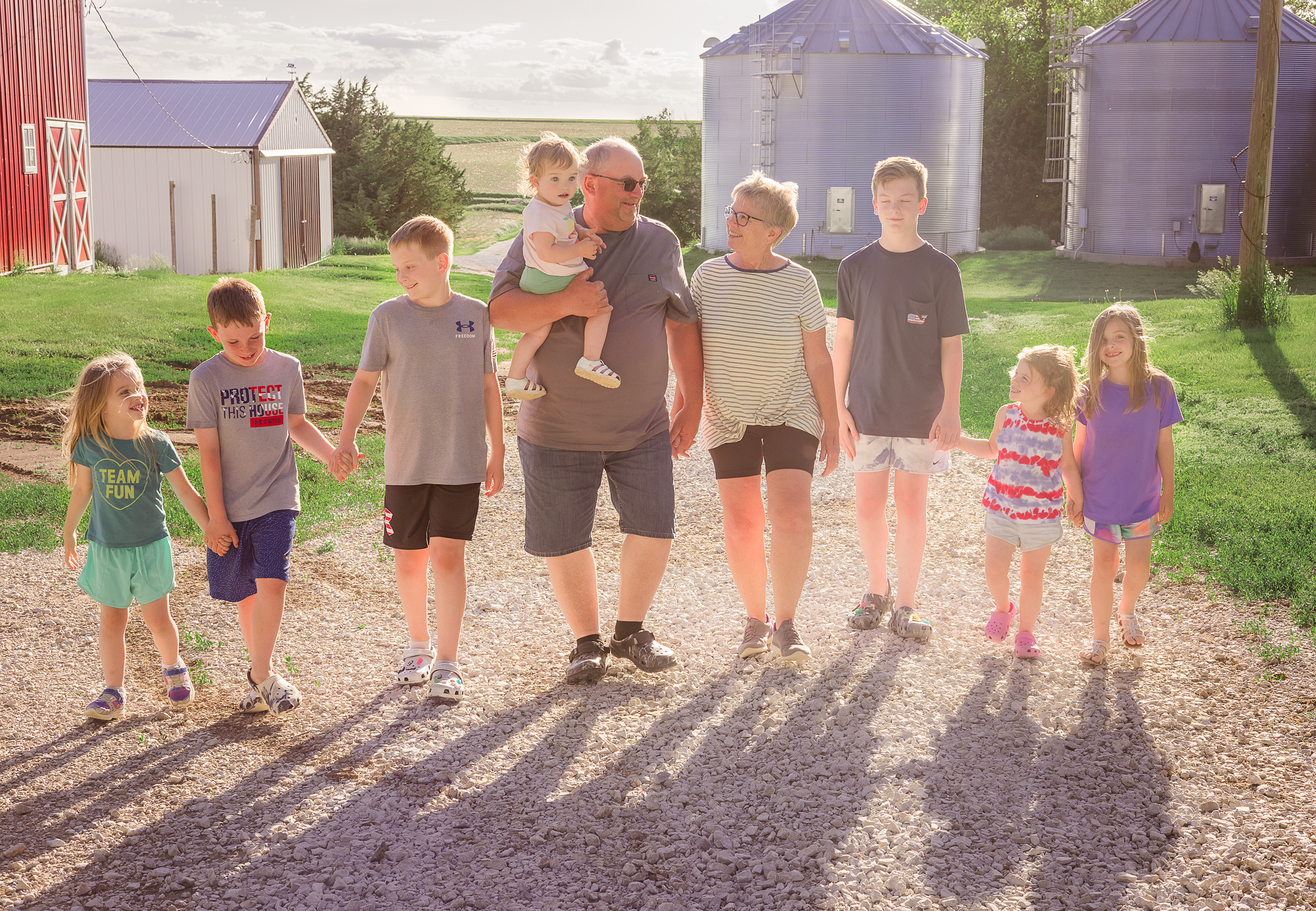 Joyful family holding hands on a Nebraska Farm.