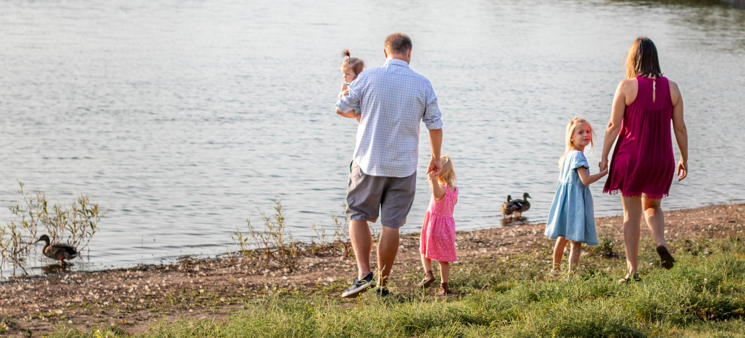 Family walking on the sand at Holmes Lake In Lincoln NE